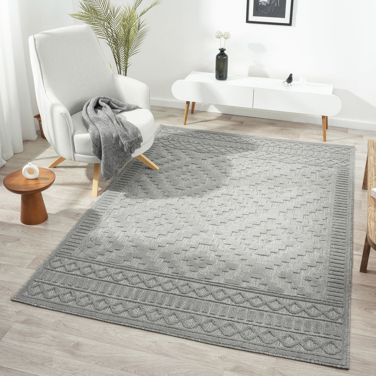 Grey geometric patterned modern rug with textured pile and subtle diamond design.
