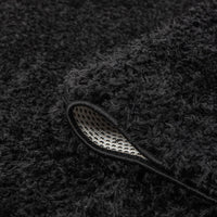 Black shaggy polyester runner rug with thick pile and non-slip backing corner detail.