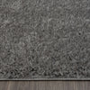 Grey and silver modern shaggy rug with thick polyester fibers and textured surface.