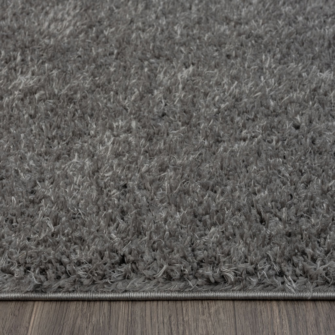 Grey and silver modern shaggy rug with thick polyester fibers and textured surface.