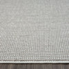 Grey flatweave rug with subtle geometric texture and clean stitched edges.