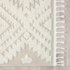 Beige runner rug with raised white geometric pattern and white fringed edges.