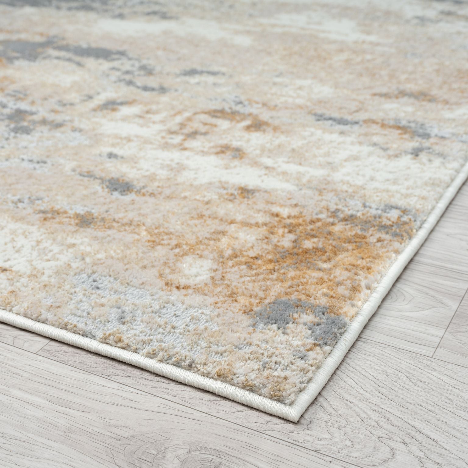 Textured area rug with earthy tones on a wooden floor
