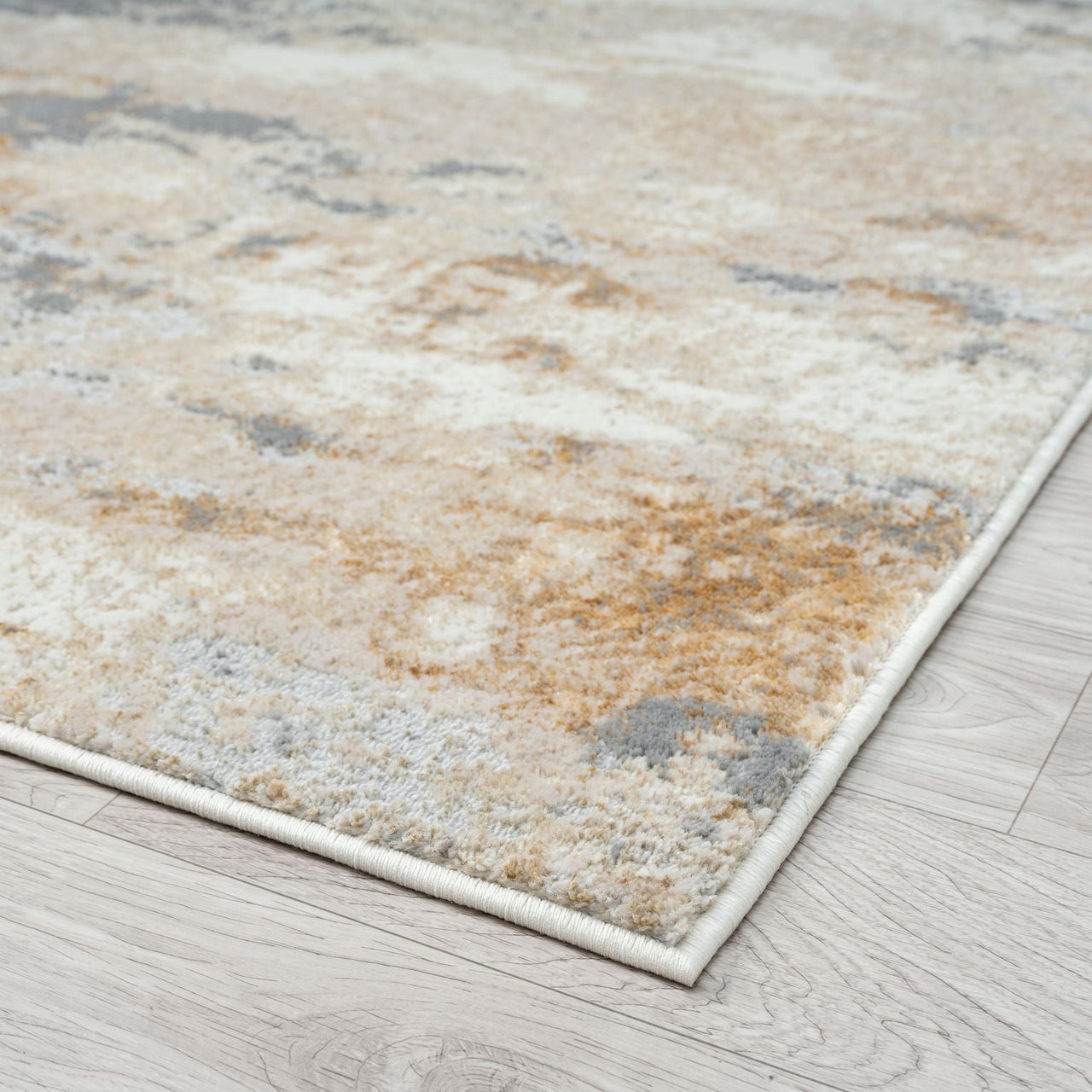 Textured area rug with earthy tones on a wooden floor
