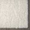 Cream-colored modern shaggy rug with soft, dense polyester fibers and a plush texture.