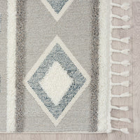 Grey and beige runner rug with modern geometric diamond pattern and fringe edges.