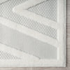 Grey and white modern rug with textured geometric zigzag pattern and border edges.