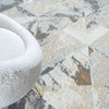 Multi-colored geometric patterned modern rug with abstract shapes in beige, gray, and brown tones.