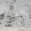 Textured gray area rug on a wooden floor