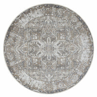Round rug with intricate vintage-inspired gray and beige pattern and distressed finish.