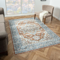 Blue and rust multi-colored transitional rug with intricate medallion pattern on wood floor.