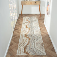 Long, narrow area rug with wavy pattern on a wooden floor
