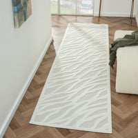 Ivory modern runner rug with textured geometric wave pattern on polypropylene pile.