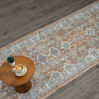 Multi-colored Easy 367 Terra Runner with intricate transitional pattern in beige, blue, and rust tones on wood floor.