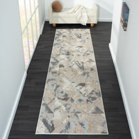Modern runner rug with beige, gray, and soft brown geometric abstract pattern on light background.