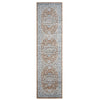 Narrow indigo runner rug with intricate beige and brown medallion pattern and faded distressed look.