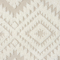 Beige and white geometric patterned rug with textured diamond shapes and fringed edges.