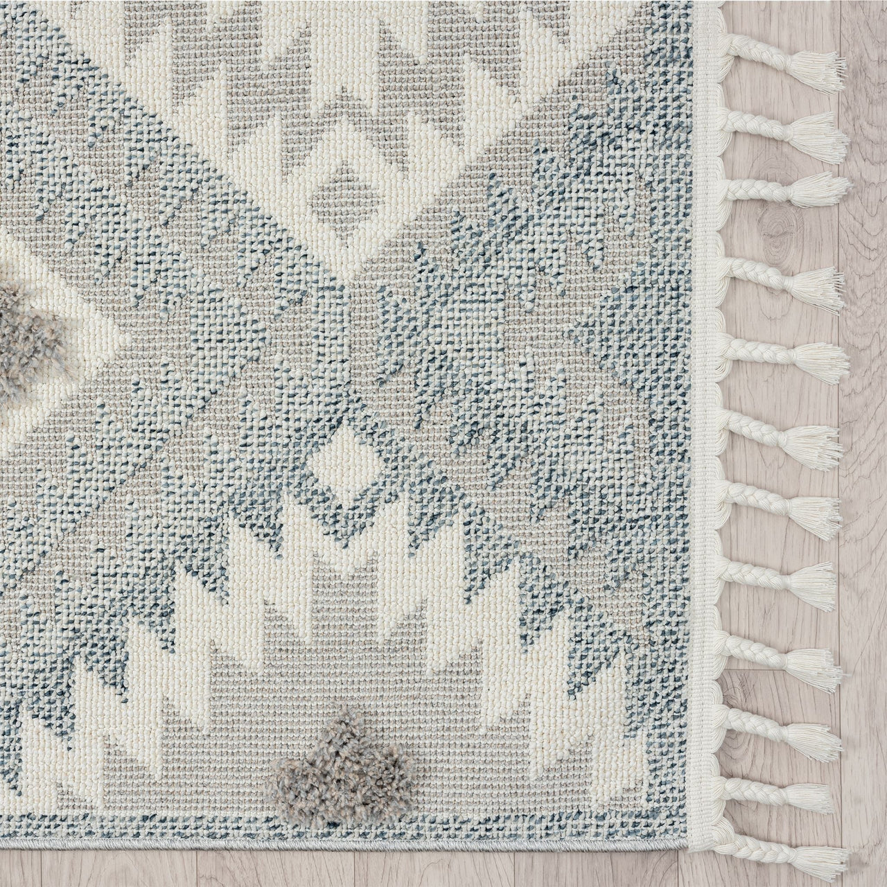 Grey and cream runner rug with modern geometric pattern and fringed edges.