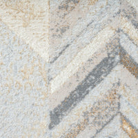 Close-up of a textured rug with beige, gray, and brown colors.