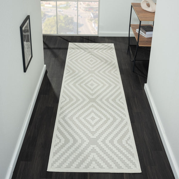 Cream runner rug with beige geometric diamond patterns on textured pile in modern hallway setting.