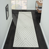 Cream runner rug with beige geometric diamond patterns on textured pile in modern hallway setting.