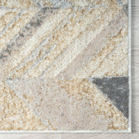 Modern runner rug with multi-colored geometric pattern in beige, gray, and cream tones.
