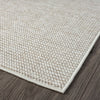 Beige flatweave rug with tight geometric pattern and clean, finished edges on wood floor.