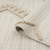 Taupe and beige geometric runner rug with textured pile and fringed edges, folded corner showing back texture.