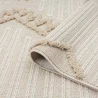 Taupe and beige geometric runner rug with textured pile and fringed edges, folded corner showing back texture.
