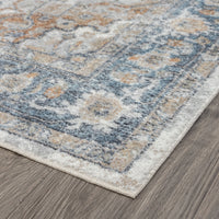 Modern transitional aqua runner rug with muted blue, beige, and cream geometric patterns on a hardwood floor.