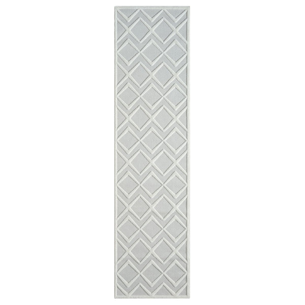 White runner rug with raised geometric diamond pattern and textured pile.
