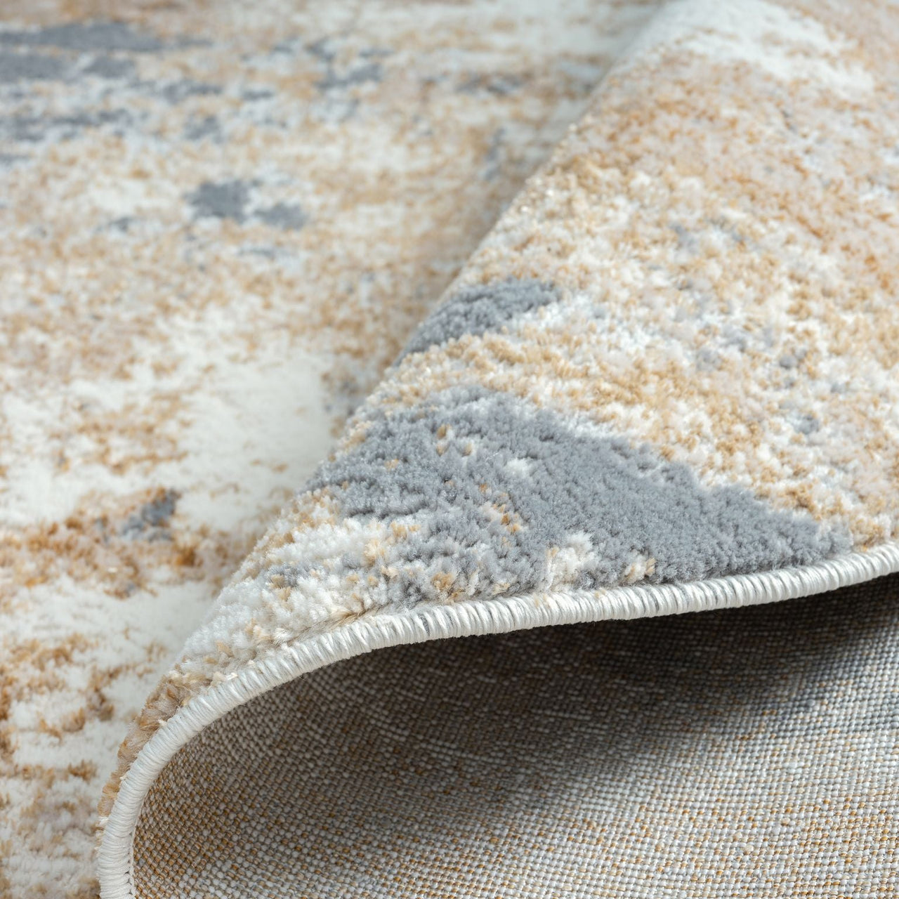 Close-up of a textured beige and gray area rug
