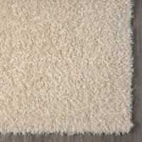 Beige modern shaggy runner rug with soft textured polyester fibers and clean edge detail.