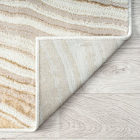 Close-up of a textured rug corner on a wooden floor