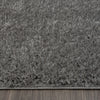 Grey shaggy runner rug with soft plush texture and subtle silver tones on hardwood floor.