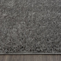 Grey shaggy runner rug with soft plush texture and subtle silver tones on hardwood floor.