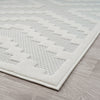 Cream rug with raised geometric pattern in soft, textured polypropylene pile on light neutral background.