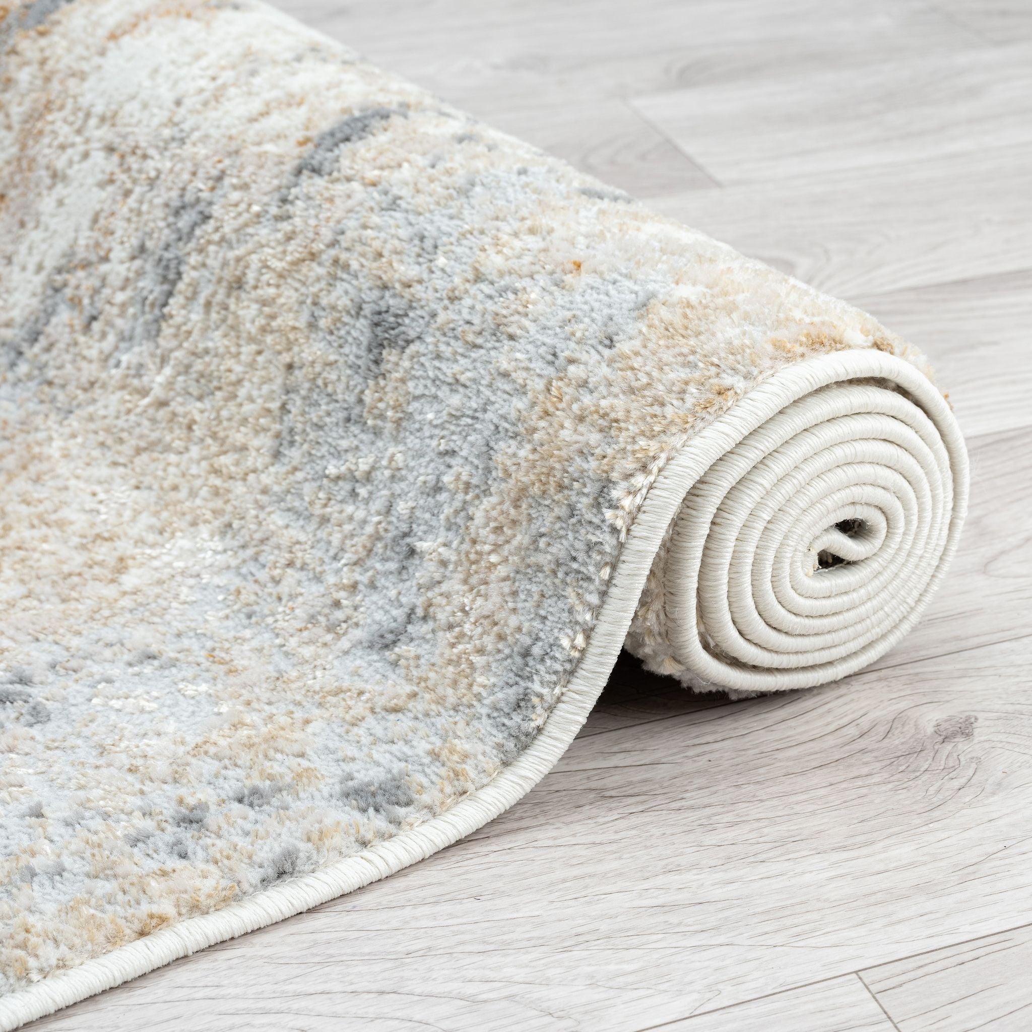 Rolled-up patterned rug on a wooden floor