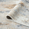Close-up of a textured area rug with a neutral color palette.