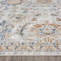 Multi-colored modern runner rug with abstract floral patterns in blue, beige, and rust tones on hardwood floor.