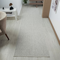 Silver grey flatweave runner rug with subtle linear texture in modern minimalist style.