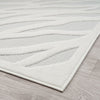 Ivory runner rug with raised geometric pattern and textured polypropylene pile on light wood floor.