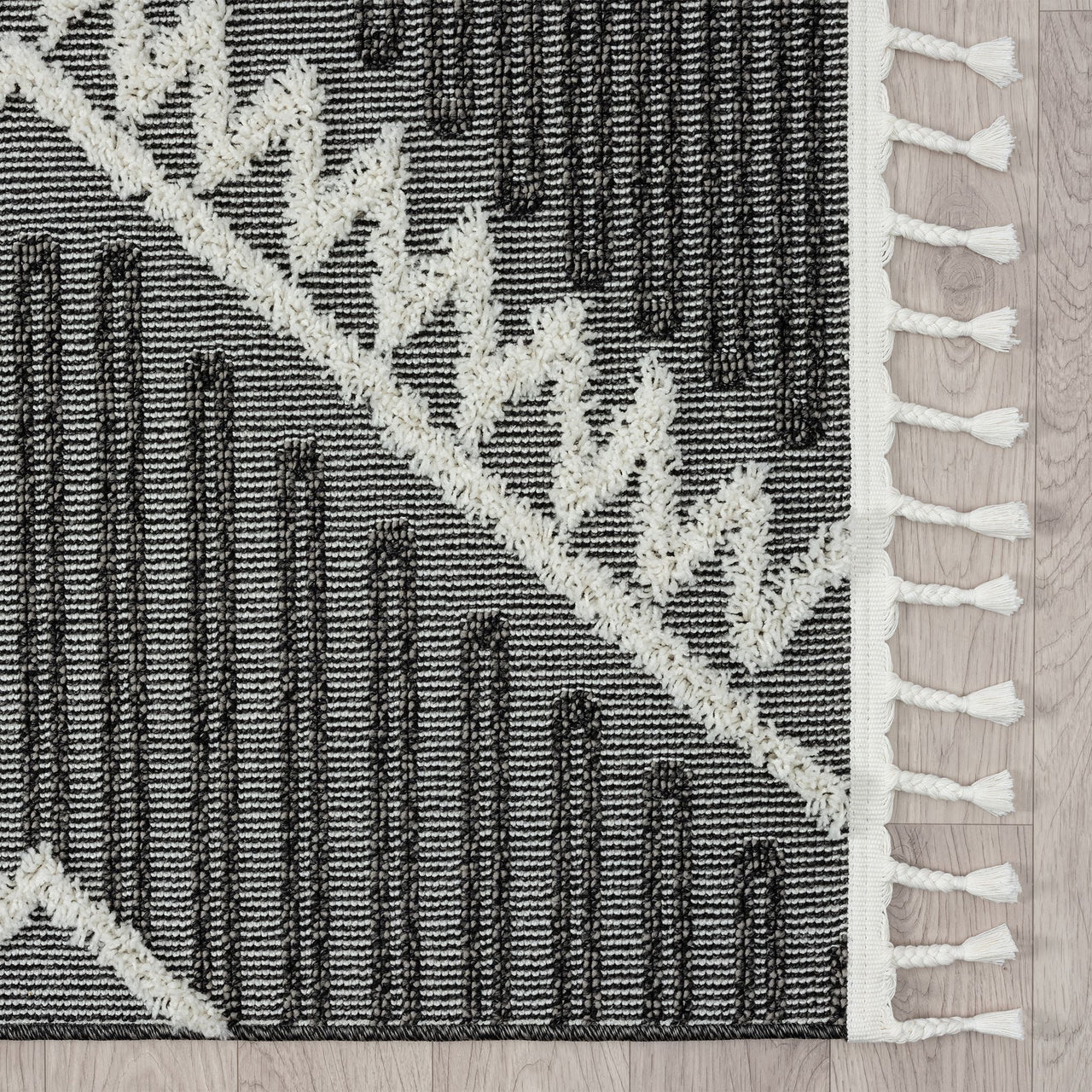 Grey and white modern geometric patterned runner rug with fringe edges and textured pile.