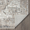 Beige and gray modern runner rug with distressed geometric pattern and folded corner showing backing.