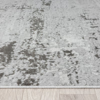 Textured gray rug on a wooden floor