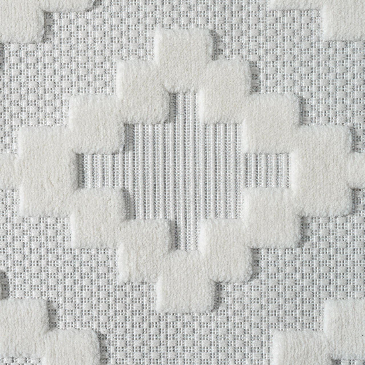 Cream and beige geometric patterned rug with textured pile and modern design.