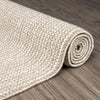 Taupe flatweave runner rug with subtle geometric texture on wooden floor.