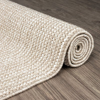 Taupe flatweave runner rug with subtle geometric texture on wooden floor.