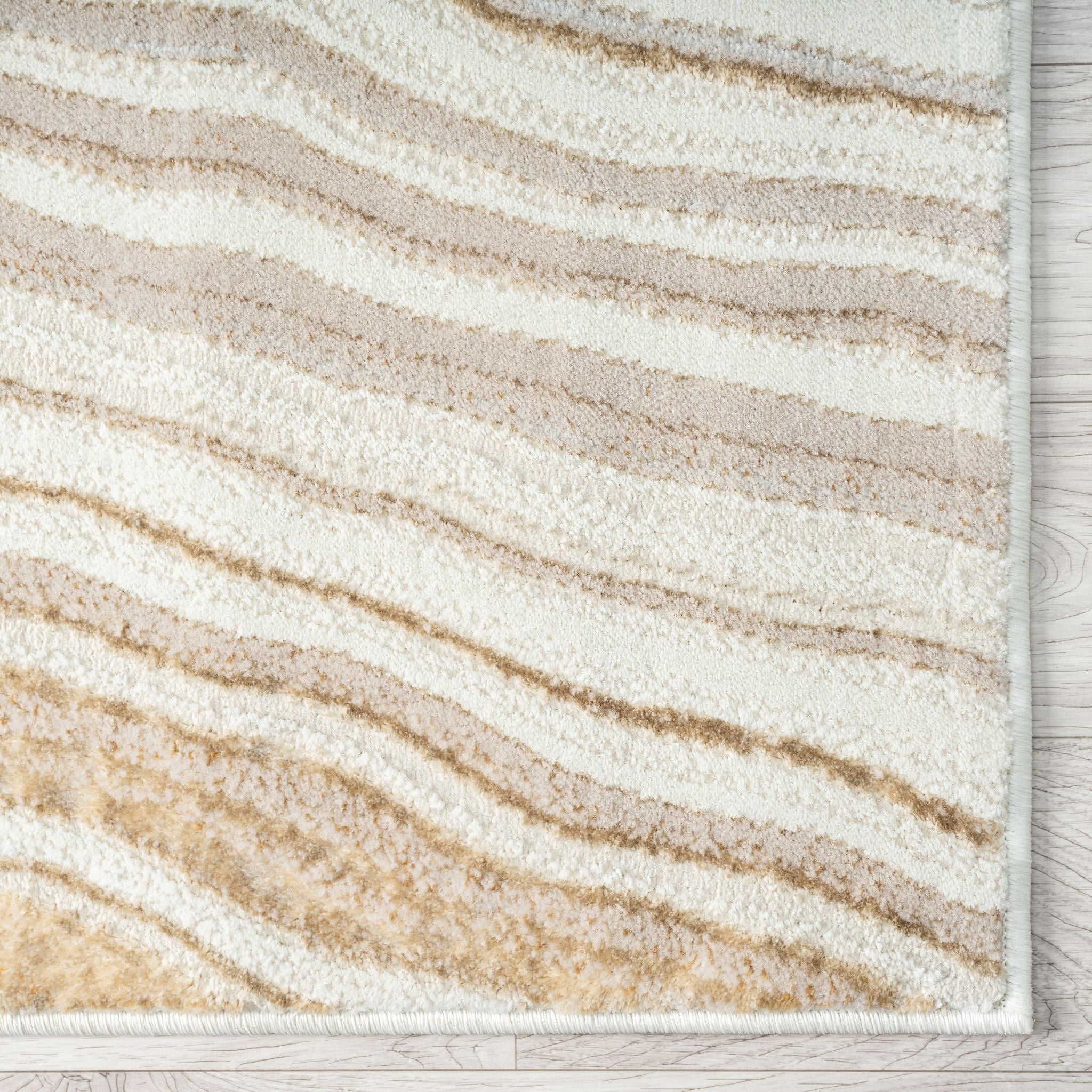Beige and white striped rug on a wooden floor