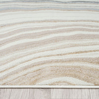 Close-up of a textured rug with wavy pattern on a wooden floor.